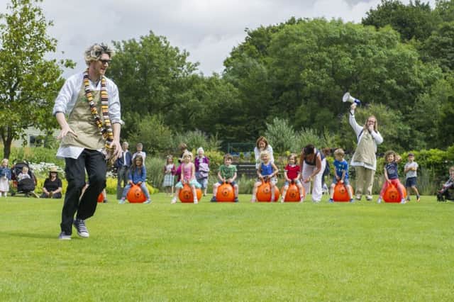 Children take part in a space hopper race on Yorkshire Day in summer at RHS Garden Harlow Carr.