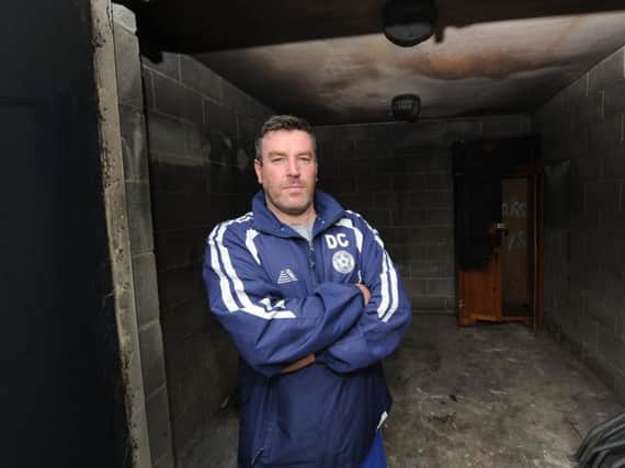 Club chairman Darren Casey, with the fire-hit building. Picture: Gerard Binks.