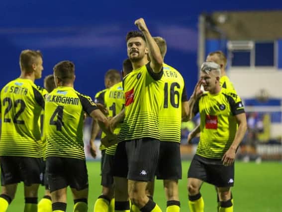 Connor Hall enjoys the moment in front of Harrogate Town's travelling supporters after scoring his side's third goal at Barrow. Picture: Matt Kirkham