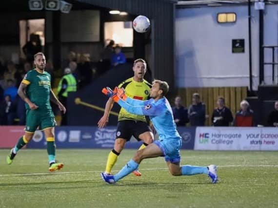 Harrogate Town striker Jack Muldoon beats Notts County's Sam Slocombe, but his effort was cleared off the goal-line. Picture: Matt Kirkham