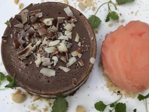 The guide describes it as a "characterful 18C coaching inn with low beams and exposed stone walls; most sit in the main room but theres also a glass-roofed courtyard and a large terrace for warmer days." Picture: Michelin Guide.