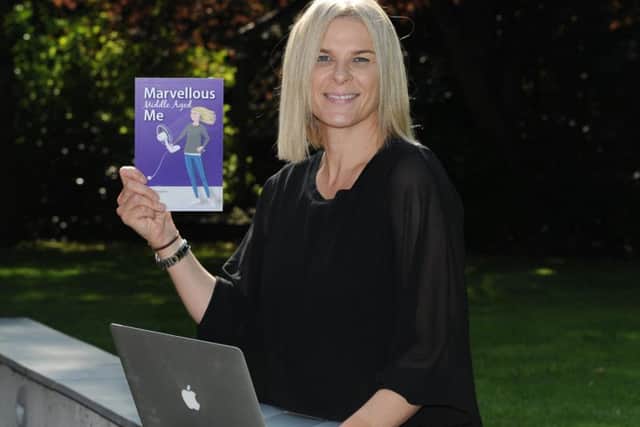 Harrogate blogger and open air swimmer Jacqui Hargrave with a copy of her new book, Marvellous Middle Aged Me.