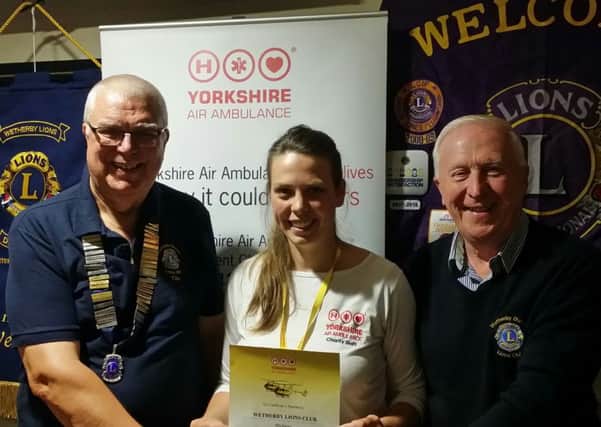 Wetherby Lions president Tim Ritson, left, and Beer Festival organiser Ken Campbell flank the Yorkshire Air Ambulances Jenny Jones at the cheque presentation.