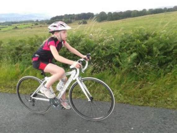 12-year-old Amy Warrington who is riding 135 miles in memory of her grandma and in support of Cancer Research. (S)