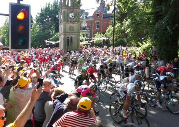 The Tour peloton passes the clocktower, metres from Simms home.