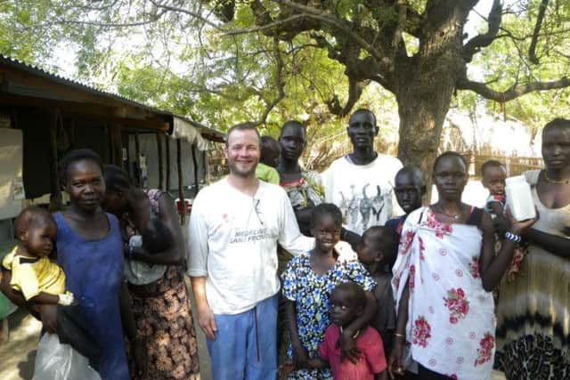 Harrogate nurse Andy Dennis at the clinic in Leer, South Sudan last December with children and carers. (S)