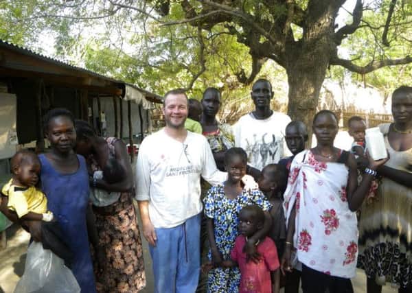 Harrogate nurse Andy Dennis at the clinic in Leer, South Sudan last December with children and carers. (S)