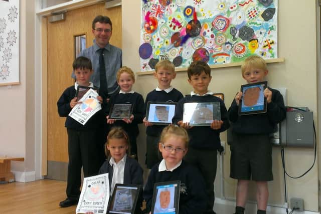 The head of Hampsthwaite Church of England Primary School with year two pupils.