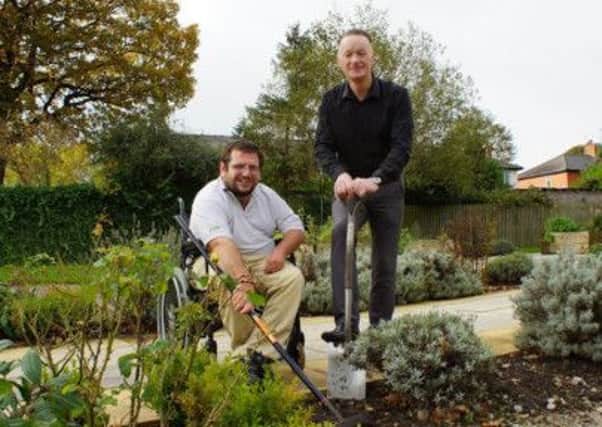 Disability Action Yorkshire Care Home Manager Steven Taylor with resident Darren Asquith in the homes garden