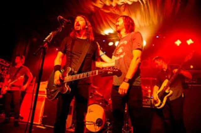 The UK Foo Fighters' Jay Apperley on stage with Dave Grohl in Brighton.