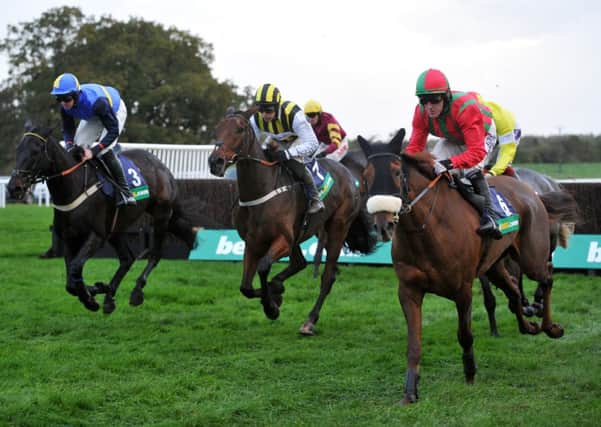 A.P.McCoy ( right) riding Benefficient leads at the half way point in the sixth race 'The Bet 365' Charlie Hall Steeple Chase at Wetherby.  (BR1001/05o)  2 November 2013. Picture Bruce Rollinson