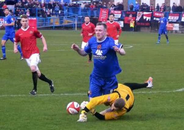 James Walshaw is felled but appeals for a penalty are waved away (Craig Hurle - Harrogate Town)