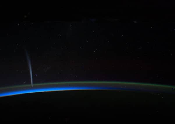 In this image provided by NASA the Comet Lovejoy is visible near Earth's horizon in this nighttime image photographed by NASA astronaut Dan Burbank, Expedition 30 commander, onboard the International Space Station on Dec. 21, 2011. (AP Photo/NASA, Dan Burbank)