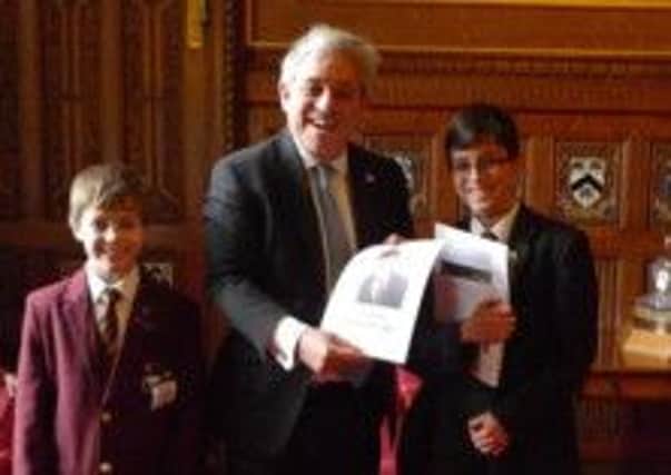 Thomas Grattoni-May (right) and his brother, Oliver, present John Bercow MP, the Speaker of the House of Commons, with the specially-made calendar.