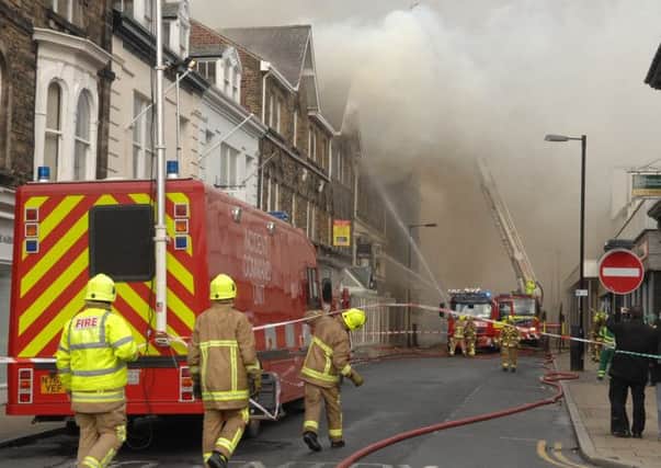 Firefighters battle the blaze on Albert Street. Picture : Adrian Murray. (1403181AM14)