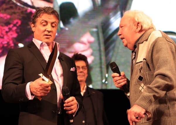 Sly Stallone is presented with a new Rambo knife by Reg Cooper. Pic: Glenn Ashley.