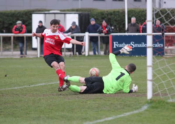 Mitch Hamilton slots in the second of his hattrick. 
By Craig Dinsdale.