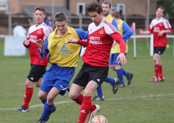 Graham Whitehead sheilds the ball from the Lincoln Moorlands defender.  By Craig Dinsdale.
