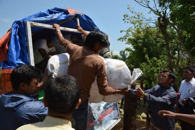 Tarpaulins and blankets are handed out in Nepal. (S)