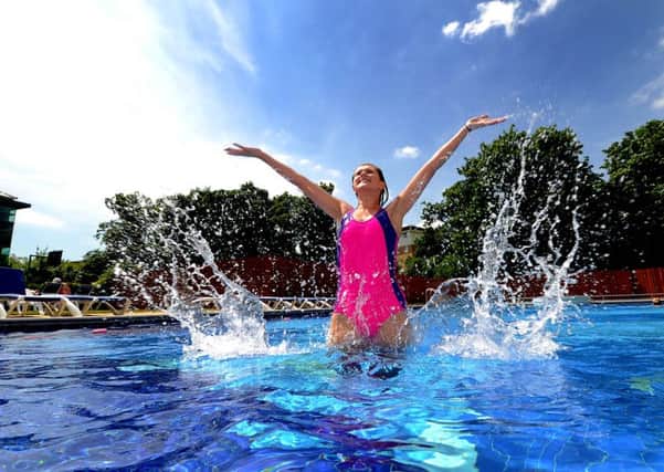 Picture James Hardisty, (JH1008/82c) Hannah Wray, 20, of Harrogate, cools off in the outdoor Swimming Pool at David Lloyd Leisure Centre, York.