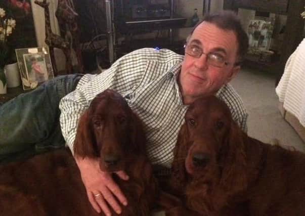 Peter Williams at home with dogs Bailey and Cody