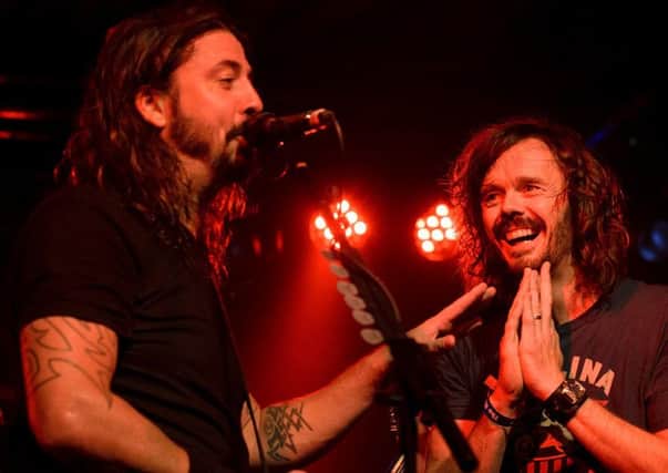 The UK Foo Fighters' Jay Apperley on stage with Dave Grohl in Brighton. (Picture by Kalpesh Patel)