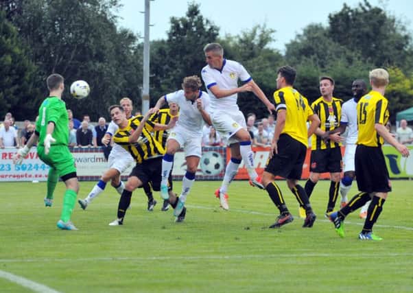 Steve Morison heads goalwards for Leeds.
