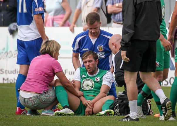 Mum Sharon Youhill attends son Robbie after he dislocates elbow against Harrogate Railway (Photo: Caught Light Photography)