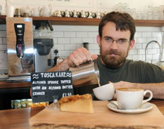 Paul Rawlinson  pouring a coffee to go with some Scandanavian Tosca cake at Baltzersens cafe which becomes Norse at nighttime.