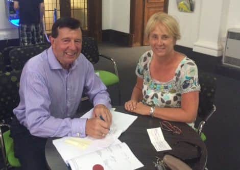 Cliff Trotter and Alison Best sign the lease agreement