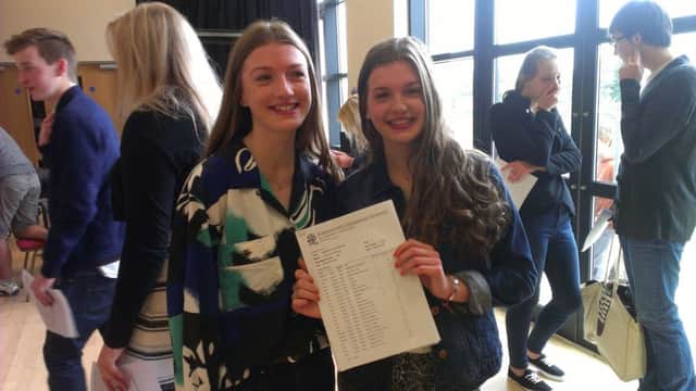 Lydia Wood stands with her sister Aimee in the HGS Sixth Form forum after collecting her GCSE results before she flies off to France for 2 weeks with her family (NADV-20-08-15 WEB)