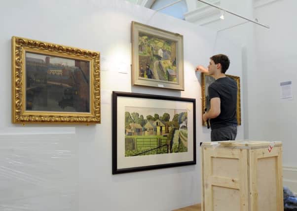 100414 Gallery Volunteer Simon Sellars putting the finishing touches to  a new exhibition 'Art and Yorkshire from Turner to Hockney ' at the Mercer Art Gallery in Harrogate which starts on Saturday. (GL100281e).