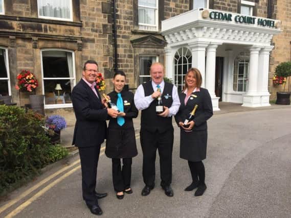 Simon Cotton, general manager of the Cedar Court Hotel in Harrogate, thanks and congratulates Marta Klos, Ian Kellor and Carla Smith on their long service.