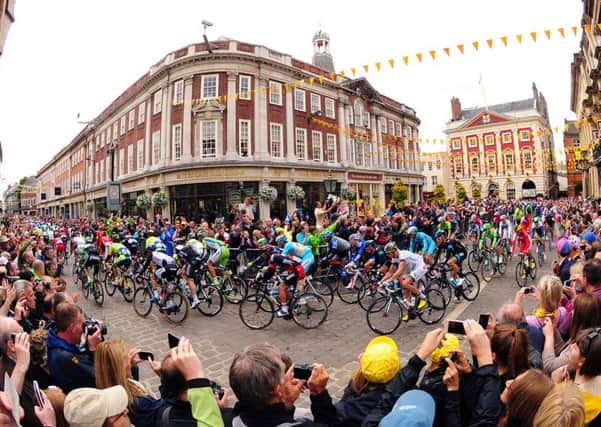 The 2014 Tour De France navigates its way through York passing Bettys Tea Rooms and the Mansion House.