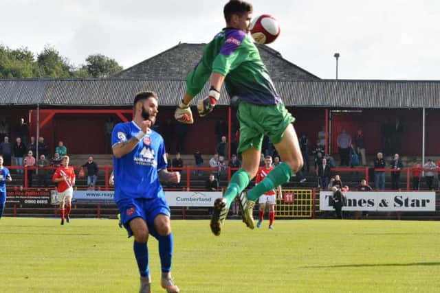 Dom Knowles is stopped in his tracks by the Workington goalkeeper (Photo: Craig Hurle)