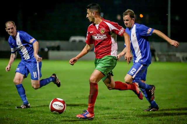 Vincent Dhesi runs with the ball, shadowed by Glossop's Nicky Matthews
