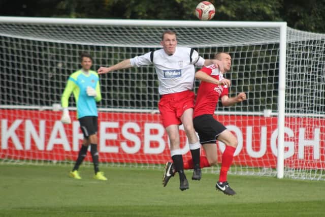 Callum Rodgers in a battle for the header.