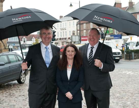 Chris Newton celebrates the deal with Calder Meynell partners Kerri Calder and Howard Meynell in Thirsk. (S)