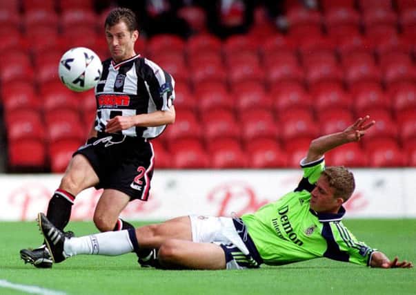 Grimsby Town's John McDermott is challenged by Fulham's Steve Finnan during his 20-year career at the club