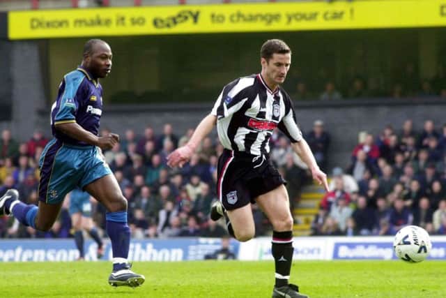 Grimsby Town's John McDermott outpaces Huddersfield Town's Clyde Wijnhard at Blundell Park. Picture: Terry Carrott
