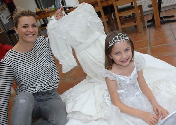 NADV 1510282AM2 Found Wedding Dress. Debbie Norris and her daughter Matilda(5) with the wedding dress and tiara found in the loft. (1510282AM2)