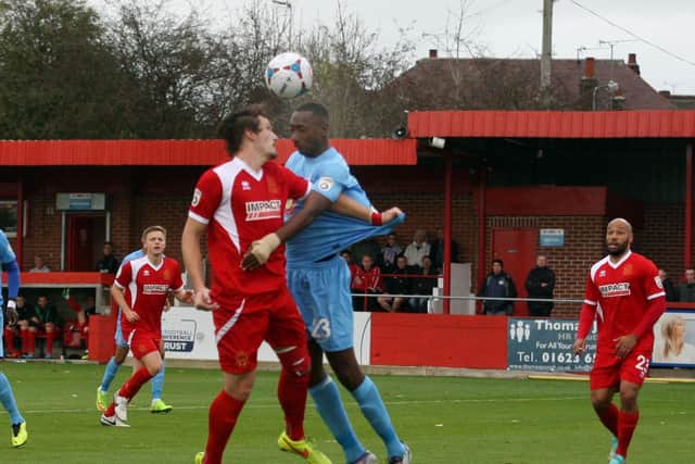 Nat Brown challenges new Harrogate Town colleague Paul Clayton, then at Alfreton.