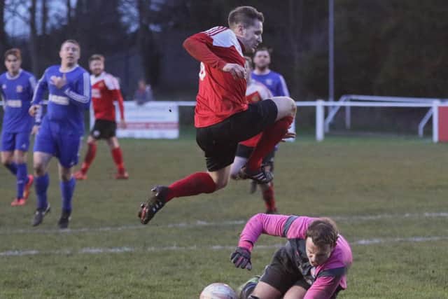 Gary Collier hurdles the keeper as he makes the save (Photo: Craig Dinsdale)
