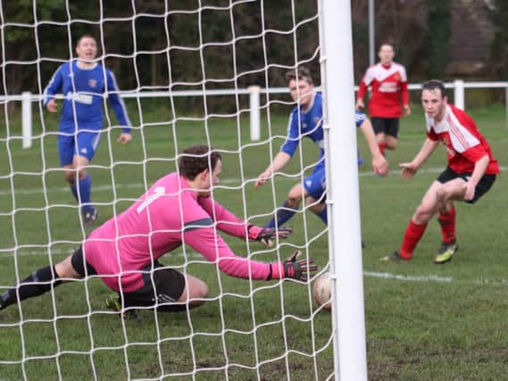 Brad Walker looks on as Adam Stevens makes a save getting his fingertips to the ball (Photo: Craig Dinsdale)