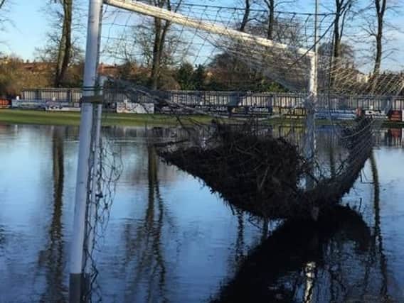 Flood and sewage water filled the pitch at the i2i Stadium over the new year
