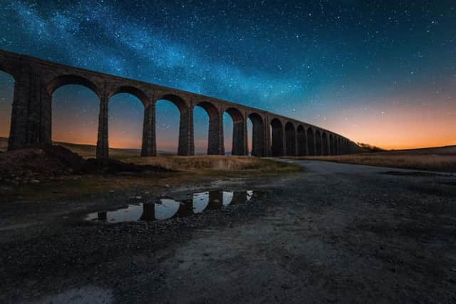 Ribblehead Viaduct silhouetted by a star-lit dark sky