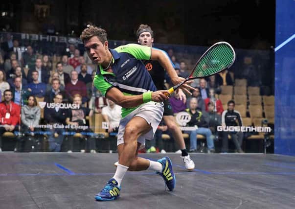 Harrogate-based Chris Simpson, background, during his first round duel with Miguel Angel Rodriguez. Picture: squashpics.com