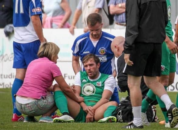 Mum Sharon Youhill attends son Robbie after he dislocates elbow against Harrogate Railway (Photo: Caught Light Photography)