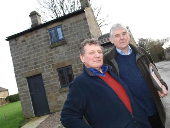 Chairman of Hampsthwaite Parish Council, David Collett, (left) and the chairman of the Hampsthwaite Village Society, Stuart Jennings, outside Saddlers Cottage. (1601252AM1). Picture: Adrian Murray.