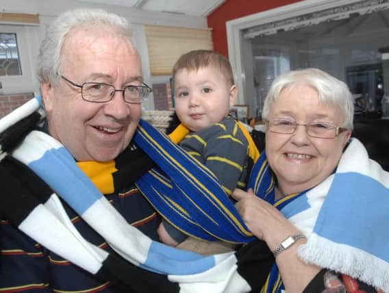Malclom and Lorna Foyle.  Malcolm and Lorna with just a few of the scarves collected on the way with their grandson Jenson Gilroy.(19months)(1603024AM4)